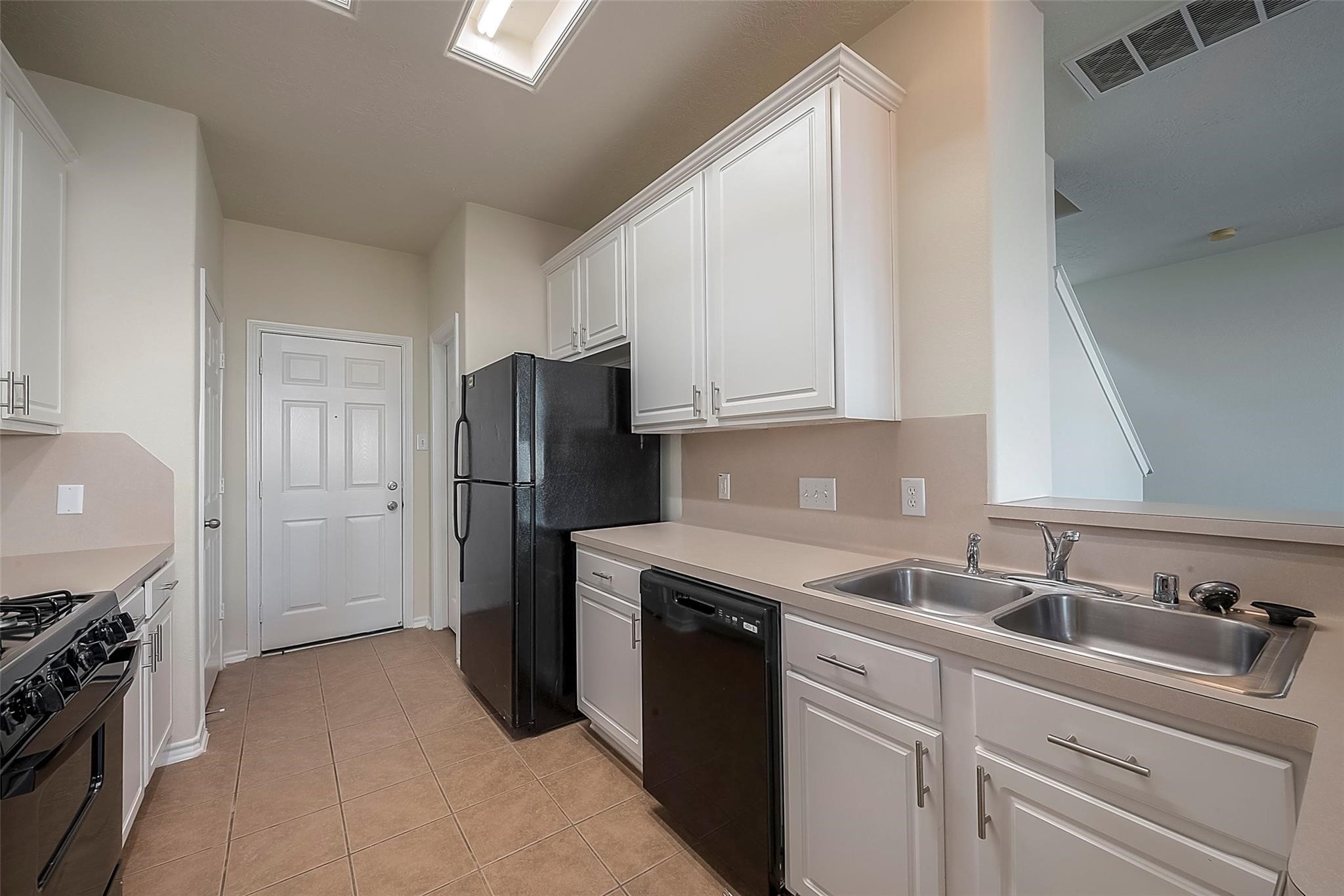 14330 Fairbuff Lane Houston, TX 77014 - Photo 14 of 35 a kitchen with a sink stove and refrigerator