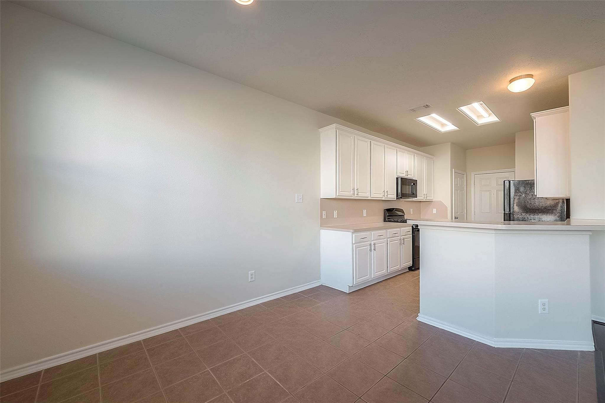 14330 Fairbuff Lane Houston, TX 77014 - Photo 18 of 35 a kitchen with white cabinets and white appliances