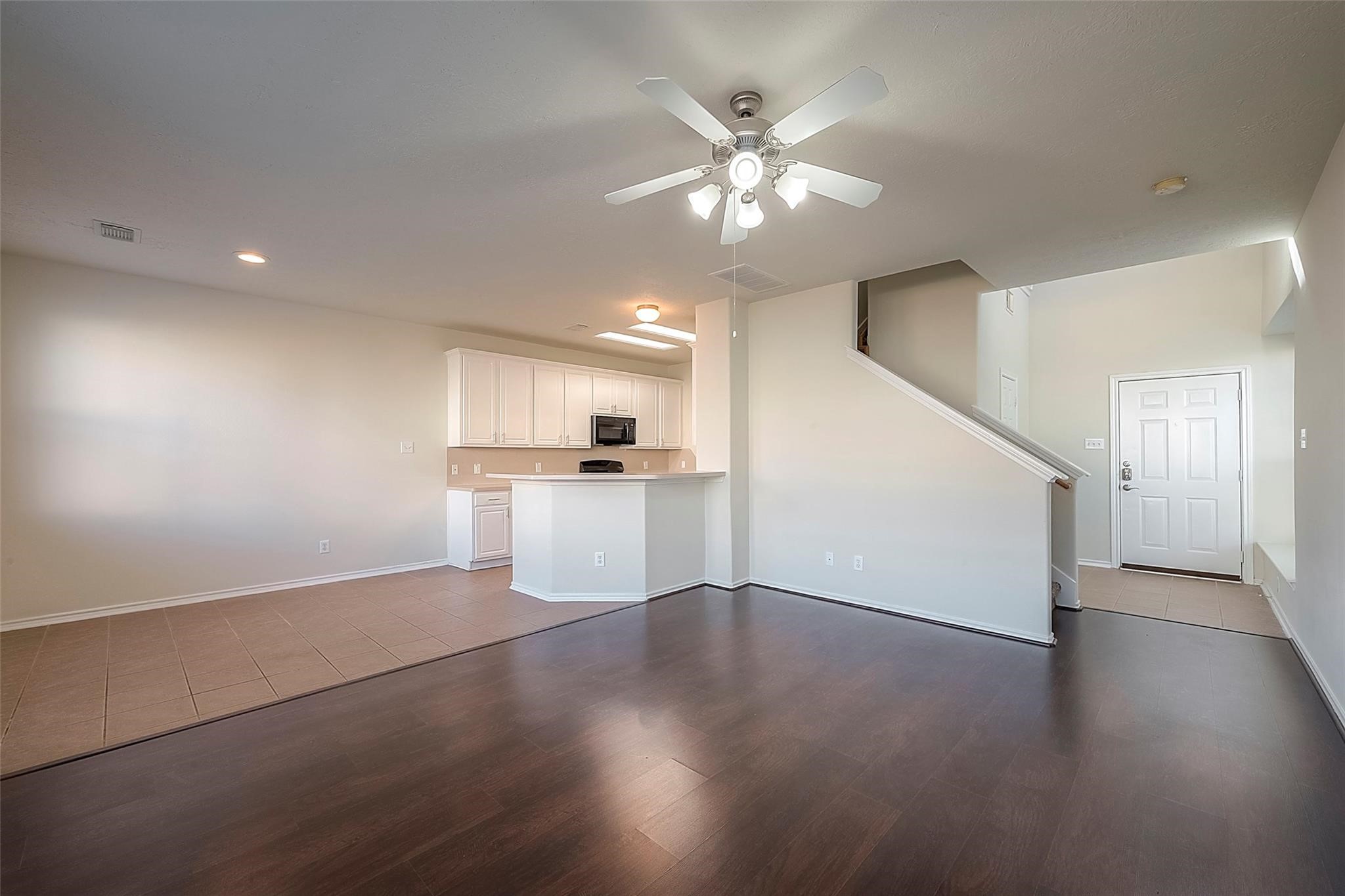 14330 Fairbuff Lane Houston, TX 77014 - Photo 3 of 35 a view of a livingroom with wooden floor and kitchen space