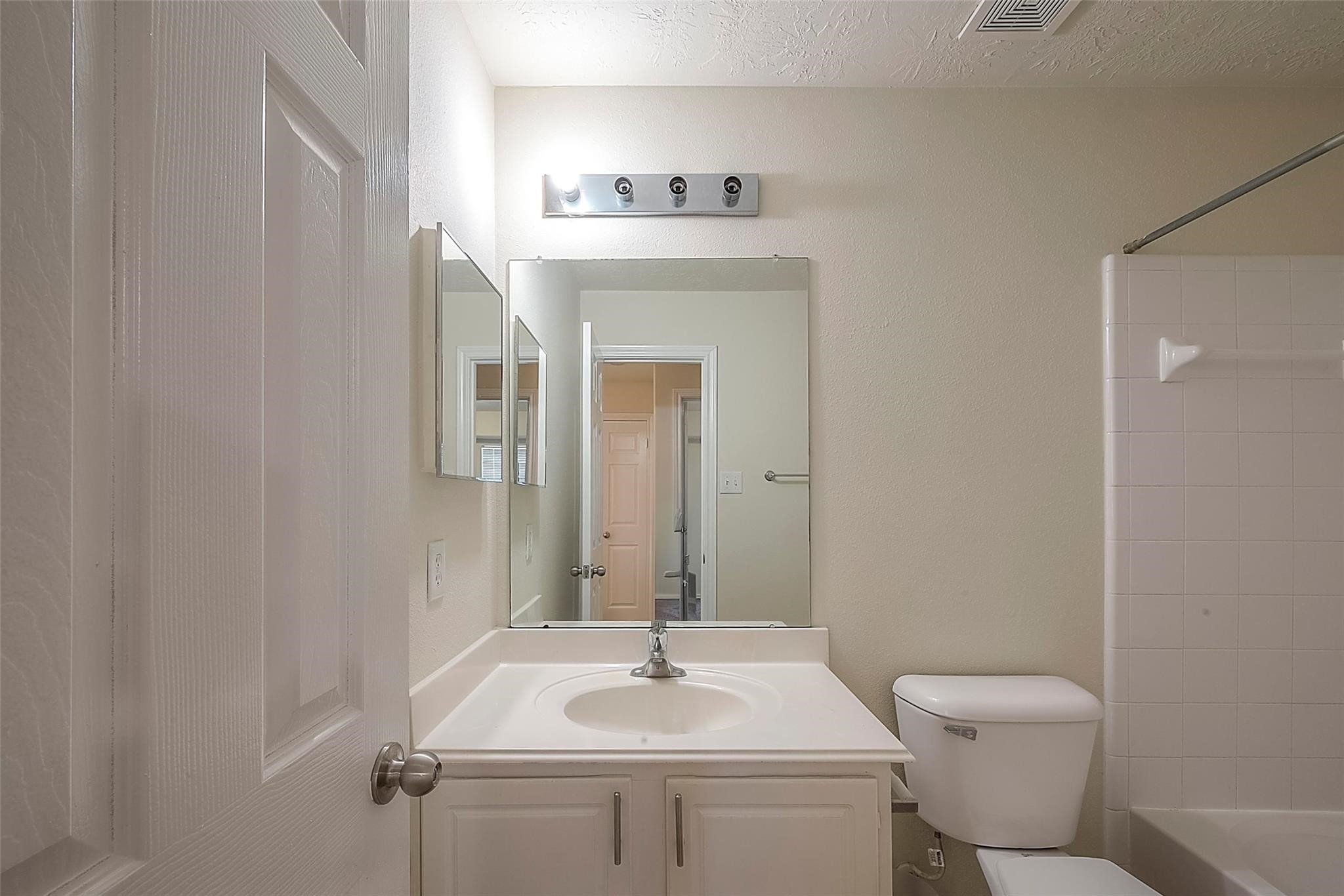 14330 Fairbuff Lane Houston, TX 77014 - Photo 31 of 35 a bathroom with a sink vanity mirror and toilet