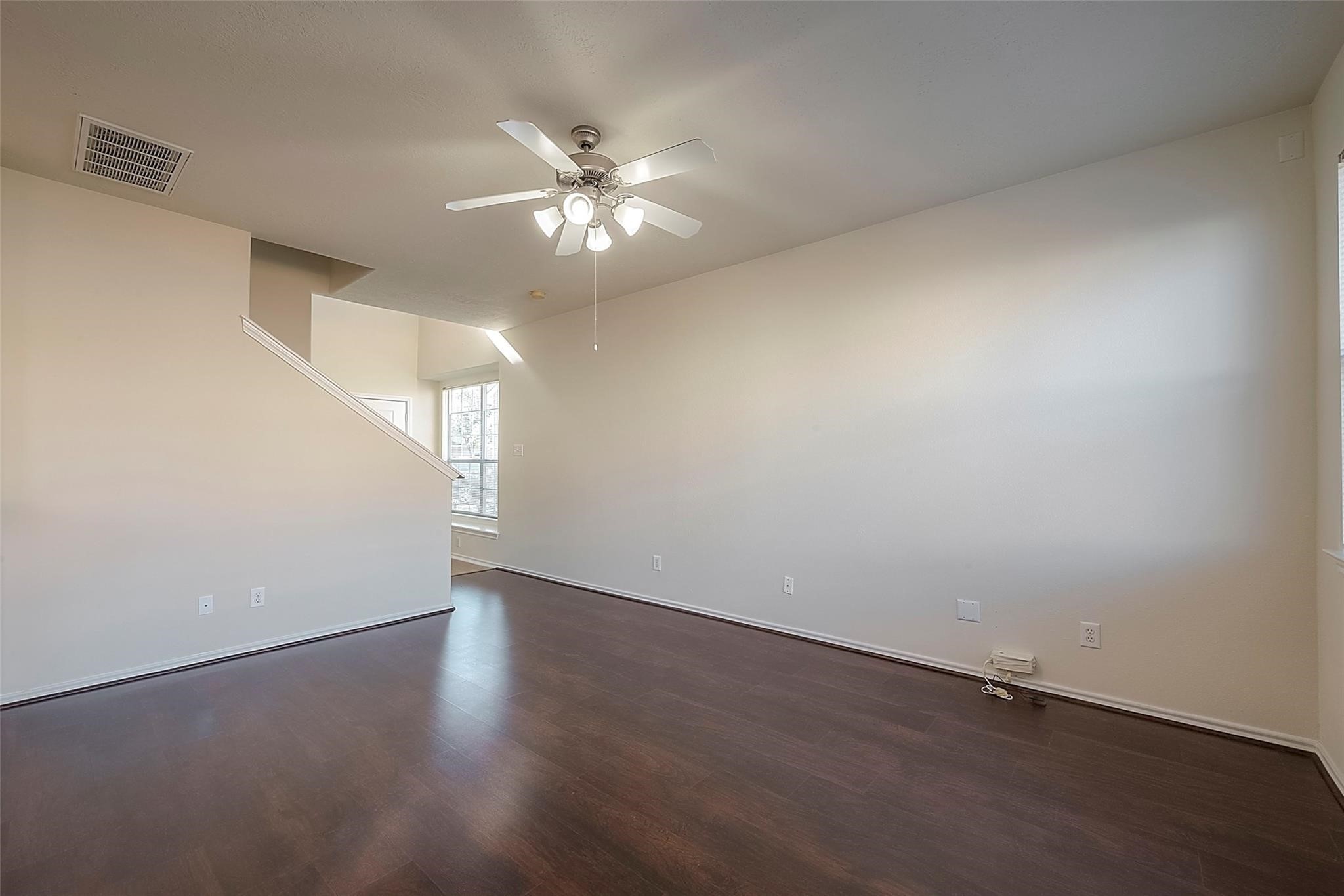 14330 Fairbuff Lane Houston, TX 77014 - Photo 4 of 35 an empty room with wooden floor fan and windows