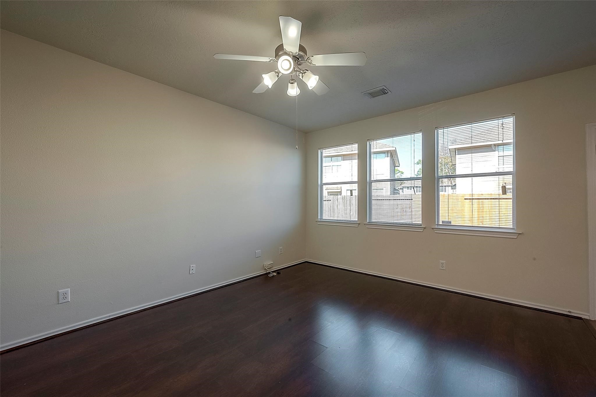 14330 Fairbuff Lane Houston, TX 77014 - Photo 5 of 35 an empty room with wooden floor and windows