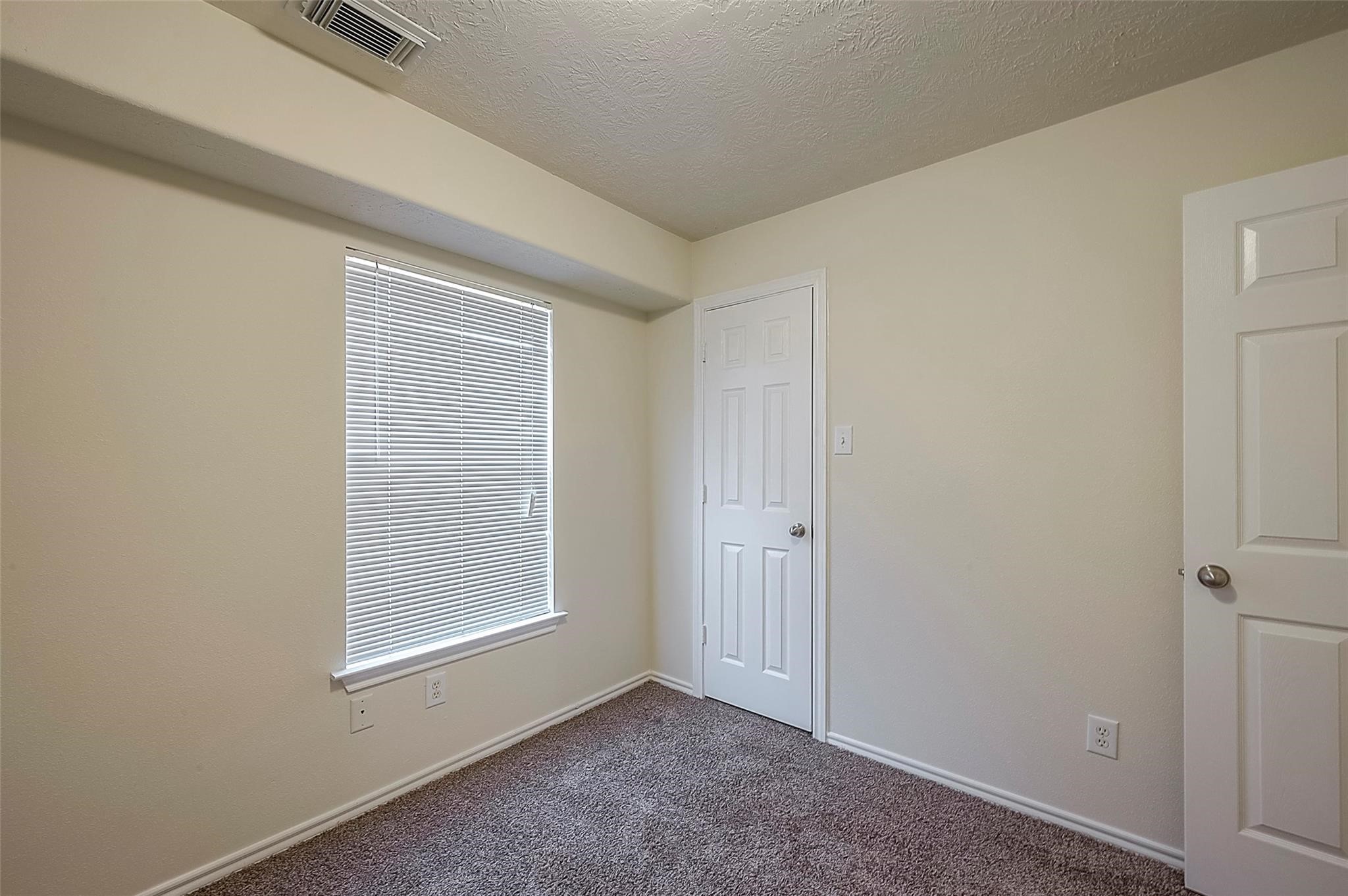 14330 Fairbuff Lane Houston, TX 77014 - Photo 10 of 35 a view of an empty room with a window