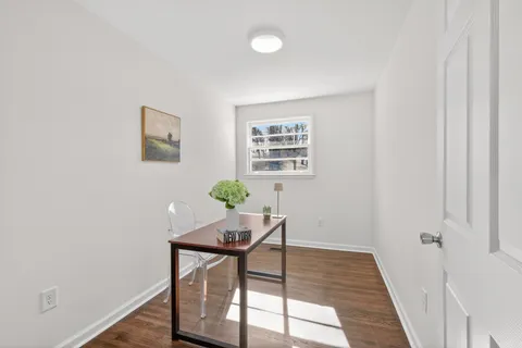a bedroom with a bed and table chair