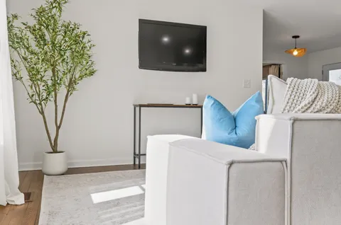 a living room with furniture and kitchen view