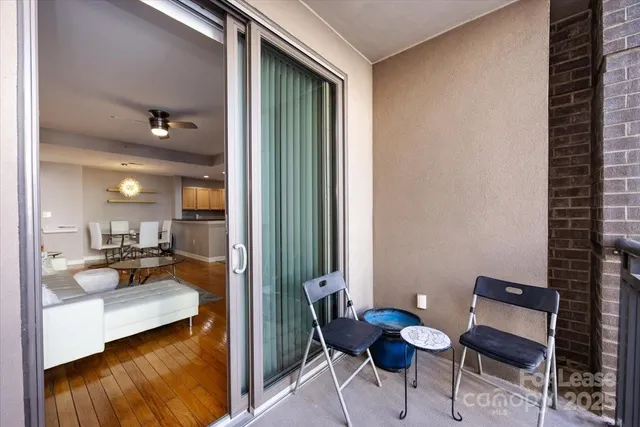 a view of a hallway and dining room with furniture