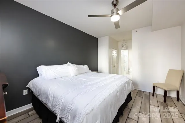 a bedroom with a bed and a chair