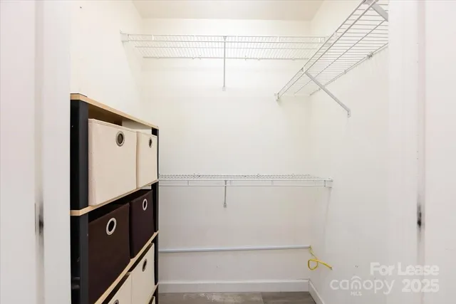 a view of a storage and utility room with racks on the wall