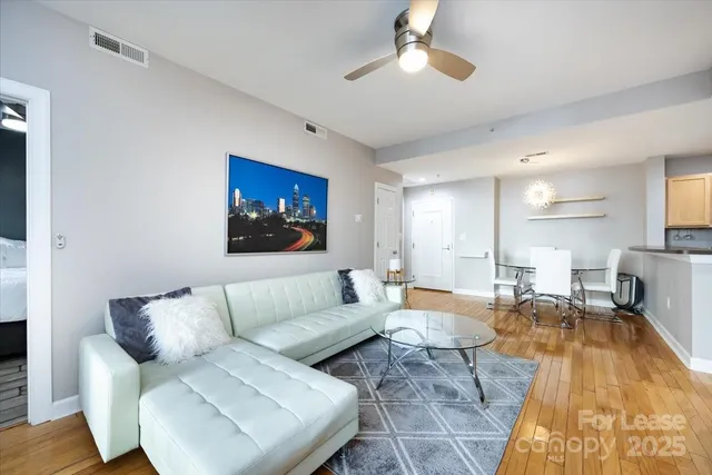 a living room with furniture a rug and a chandelier