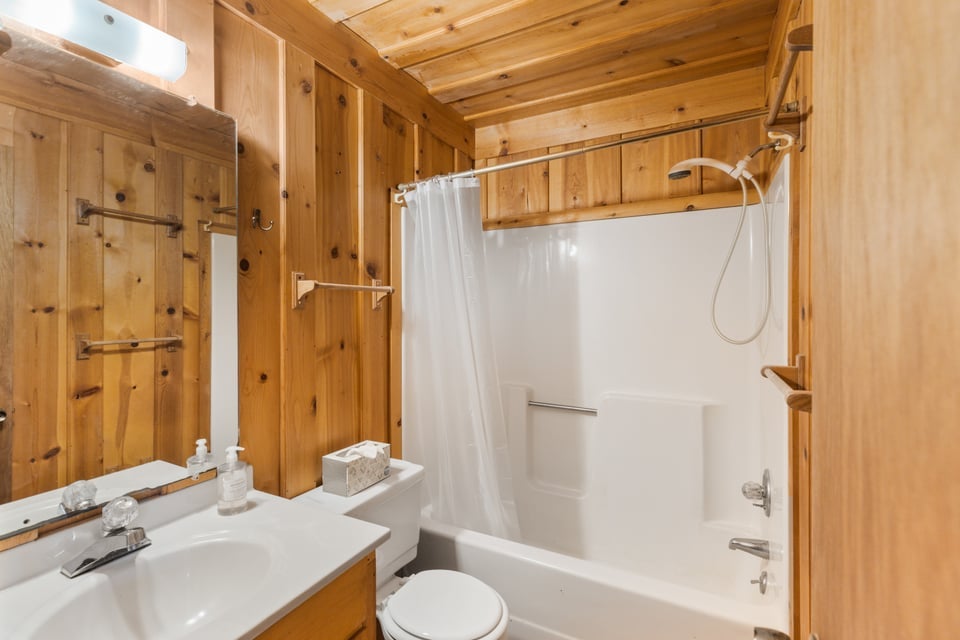 795 Buck Falls Road Highlands, NC 28741 - Photo 31 of 39 Hallway full bathroom with tub and shower combination and new luxury vinyl plank flooring