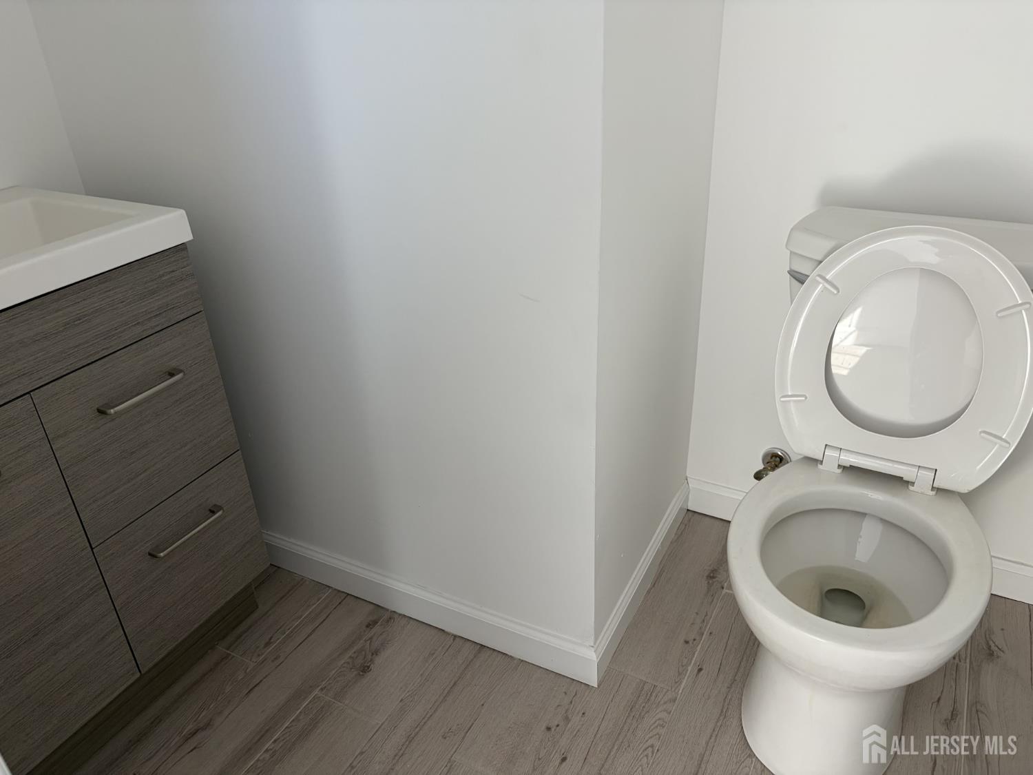 15 Fitch Street Carteret, NJ 07008 - Photo 2 of 8 a bathroom with a toilet and a sink