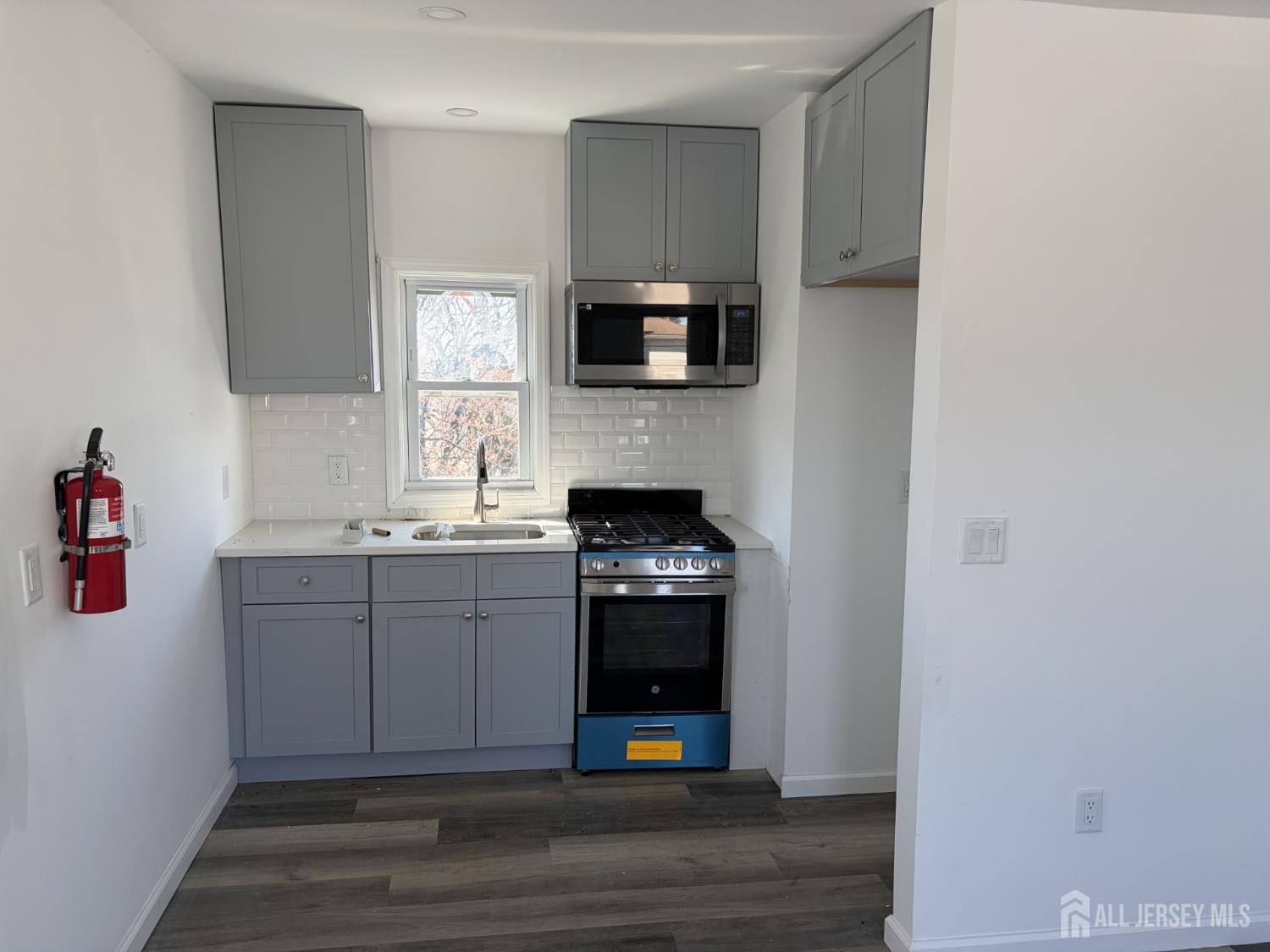 15 Fitch Street Carteret, NJ 07008 - Photo 6 of 8 a kitchen with stainless steel appliances granite countertop a stove and a refrigerator