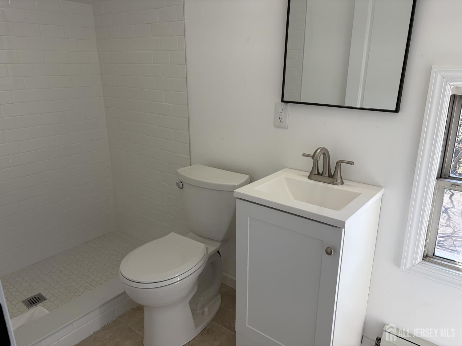 15 Fitch Street Carteret, NJ 07008 - Photo 8 of 8 a bathroom with a toilet sink and mirror