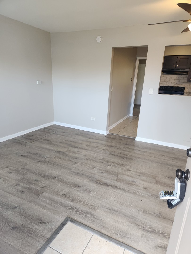 1340 North Main Street, Unit A8 Wheaton, IL 60187 - Photo 3 of 7 a view of a livingroom with wooden floor