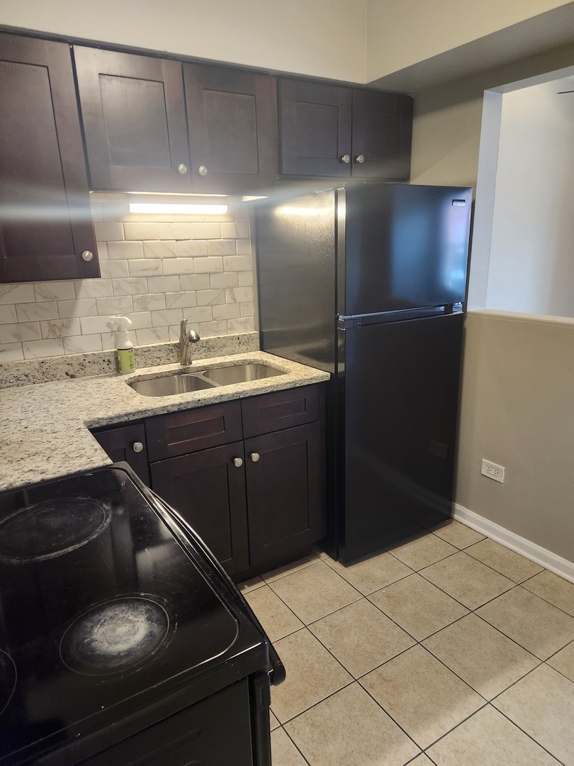 1340 North Main Street, Unit A8 Wheaton, IL 60187 - Photo 4 of 7 a kitchen with a sink and cabinets
