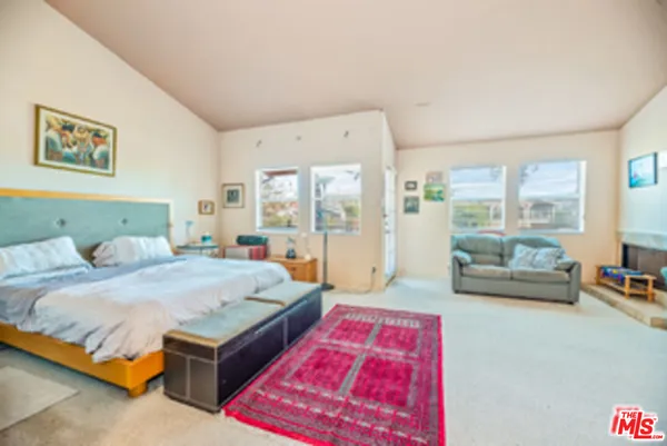 a bedroom with a bed and a couch
