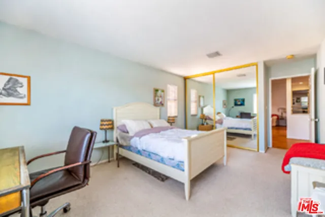 a bathroom with a double vanity sink toilet mirror and shower
