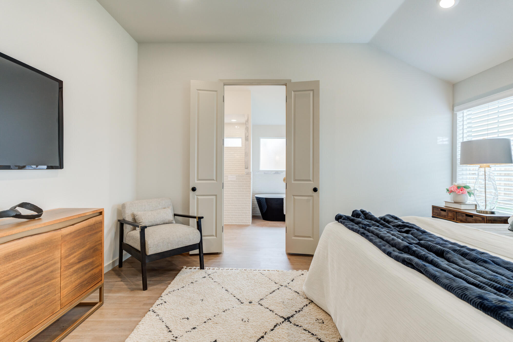 3627 122nd Street Lubbock, TX 79423 - Photo 26 of 49 a bedroom with a bed and a flat screen tv