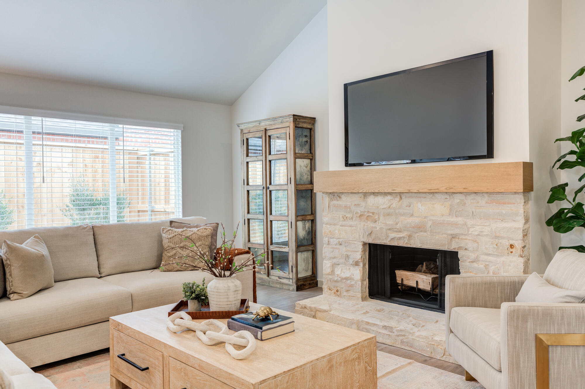 3627 122nd Street Lubbock, TX 79423 - Photo 8 of 49 a living room with furniture a flat screen tv and a fireplace