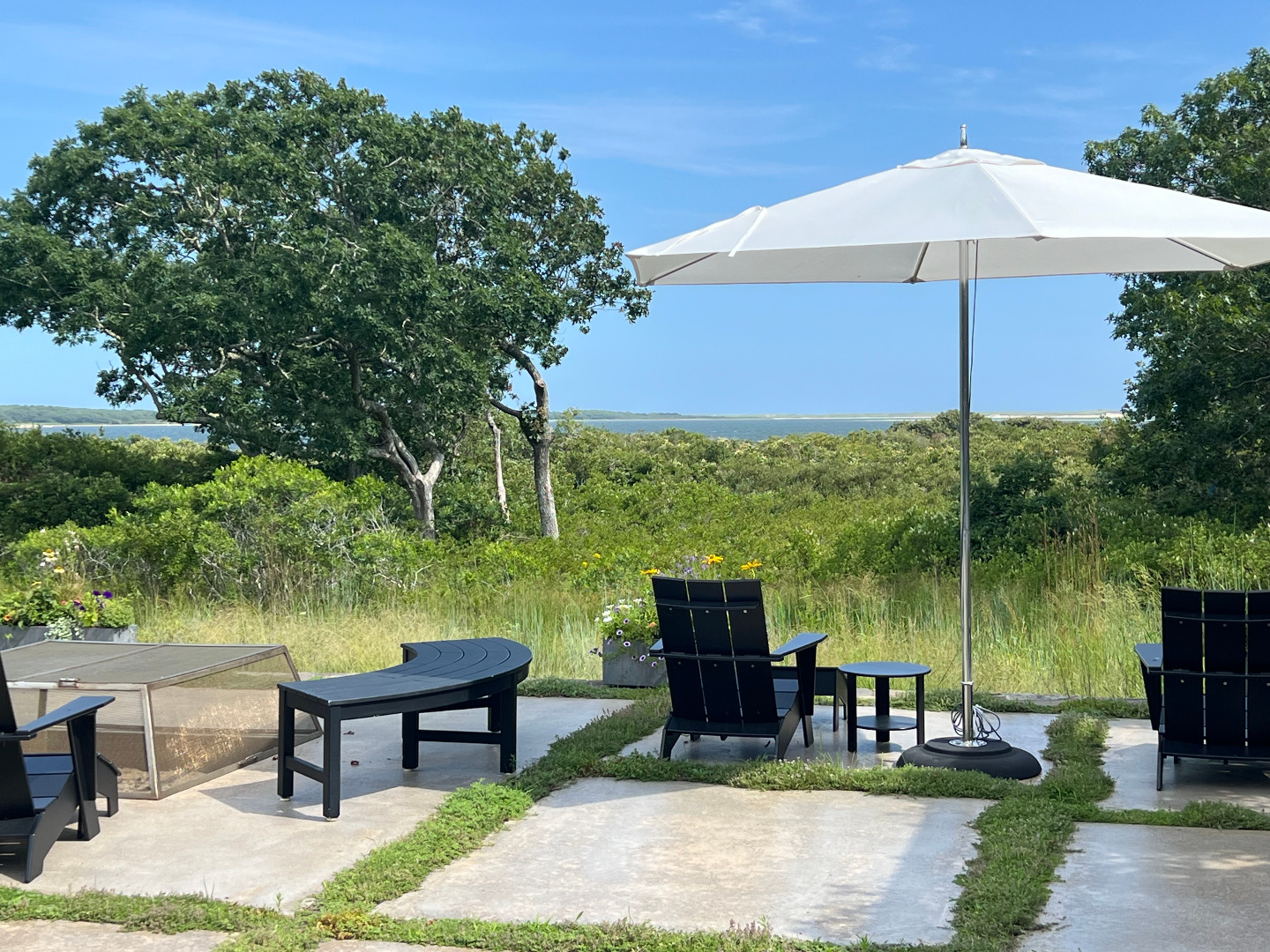33 Boldwater Road Edgartown, MA 02539 - Photo 15 of 20 a backyard of a house with table and chairs under an umbrella