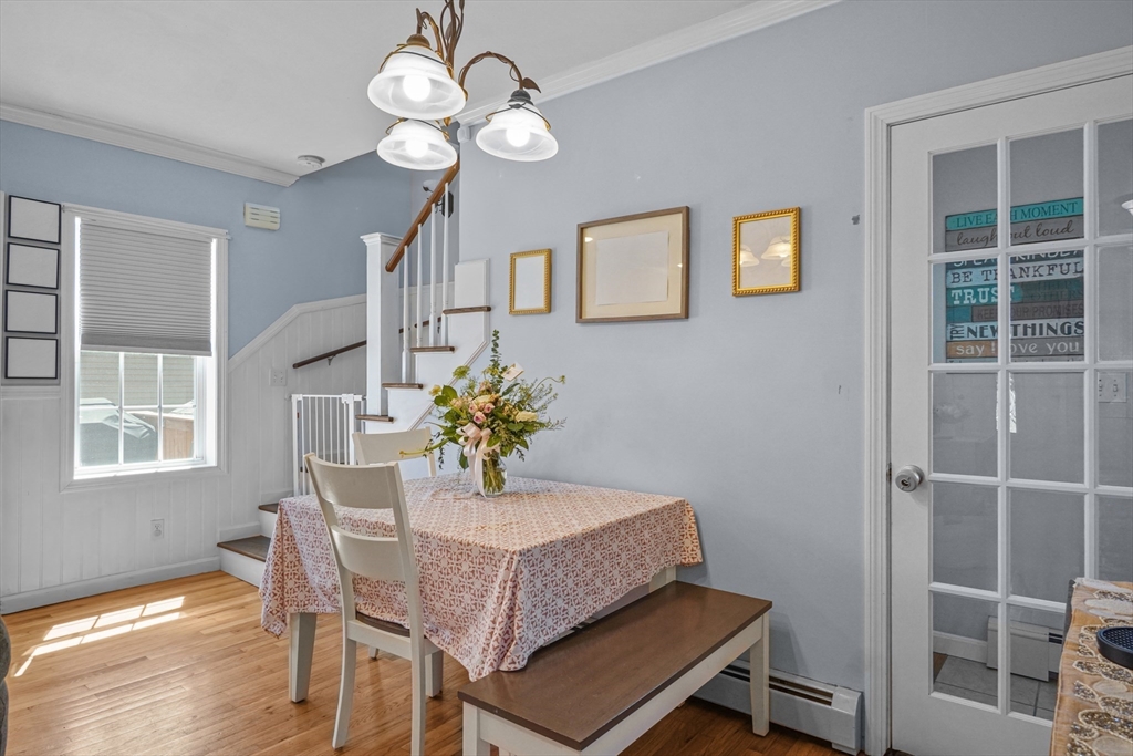 249 Baird Street Fall River, MA 02721 - Photo 6 of 23 a dining room with wooden floor and a chandelier