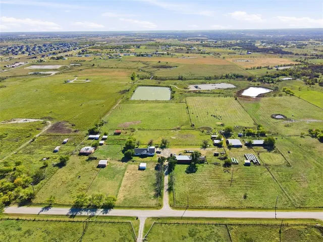 an aerial view of residential houses with pool