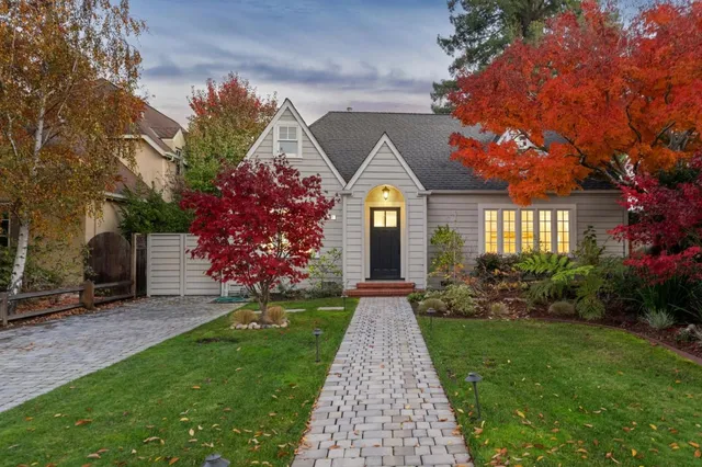 a front view of a house with a garden