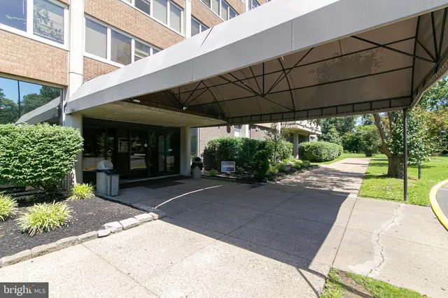 a view of a patio with a table and chairs under an umbrella