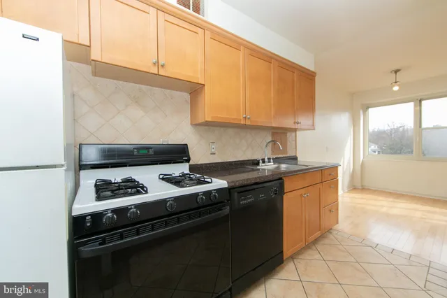 a kitchen with granite countertop a stove and a sink