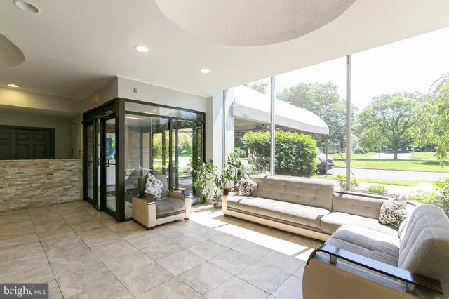 a living room with furniture and large windows