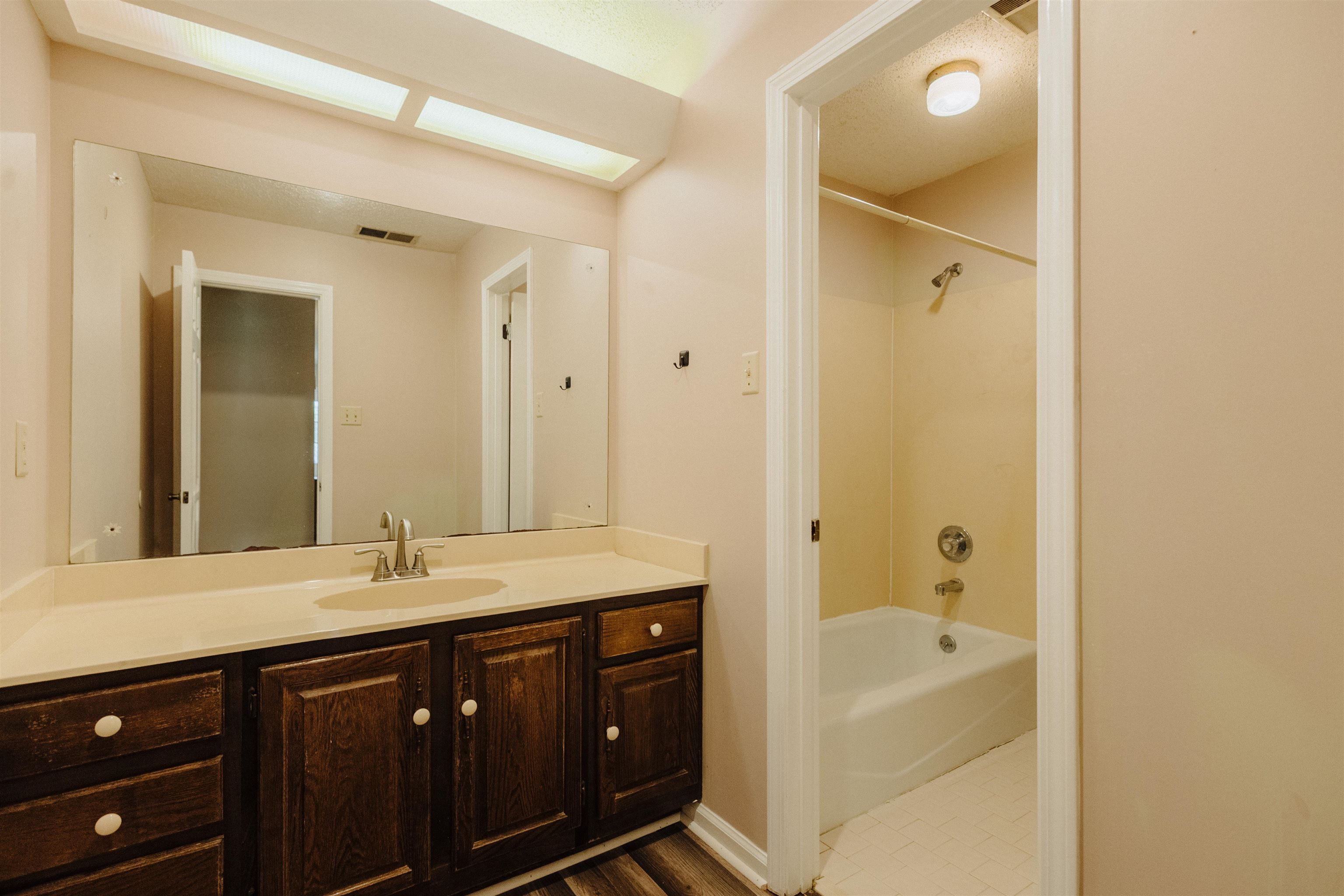 2375 Cherry Spring Cove Memphis, TN 38016 - Photo 25 of 33 a bathroom with a tub a sink and a mirror