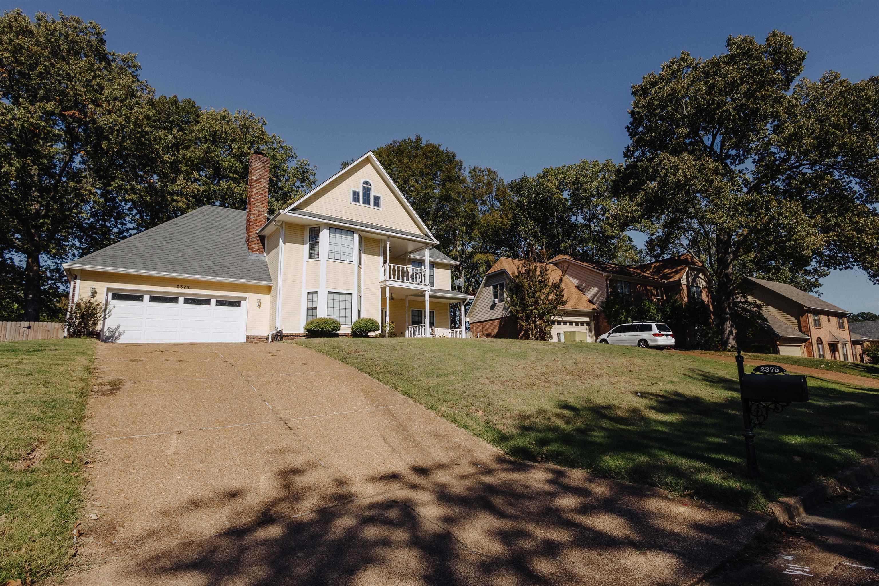 2375 Cherry Spring Cove Memphis, TN 38016 - Photo 4 of 33 a view of a big house with a big yard and large trees
