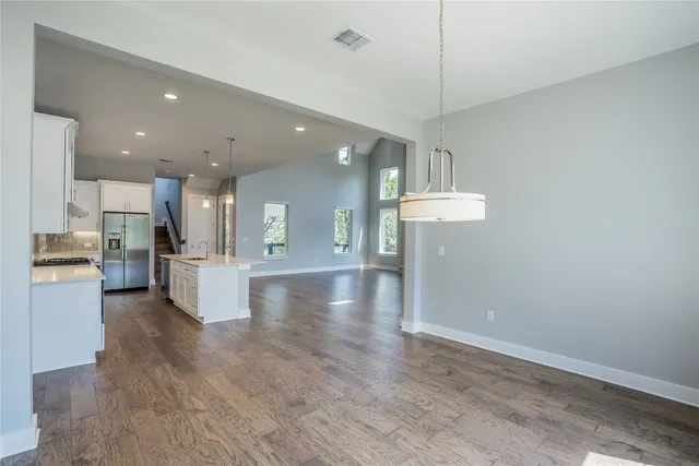a view of a kitchen with cabinets appliances and a ceiling fan