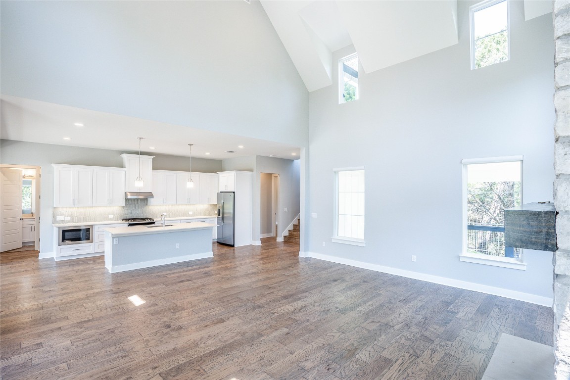 3018 Sunridge Drive, Unit 4 Austin, TX 78741 - Photo 12 of 34 a view of a kitchen with kitchen island a sink wooden floor and a large window