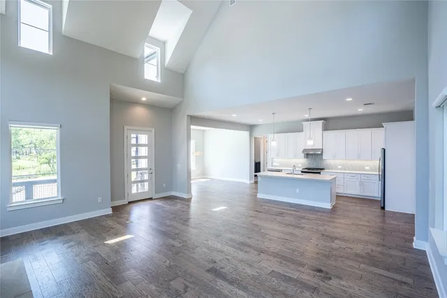 a view of kitchen with kitchen island wooden floors wooden floor and window