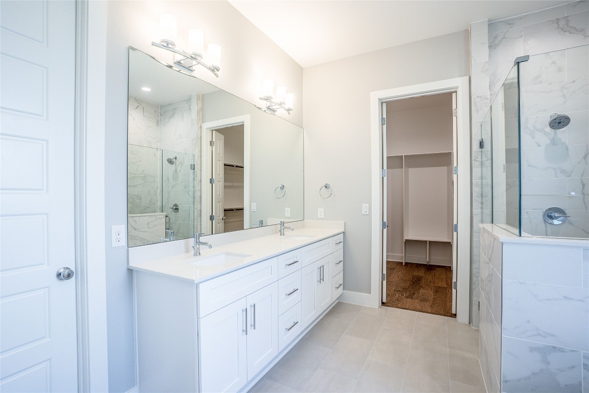 3018 Sunridge Drive, Unit 4 Austin, TX 78741 - Photo 16 of 34 a spacious bathroom with a double vanity sink mirror and shower