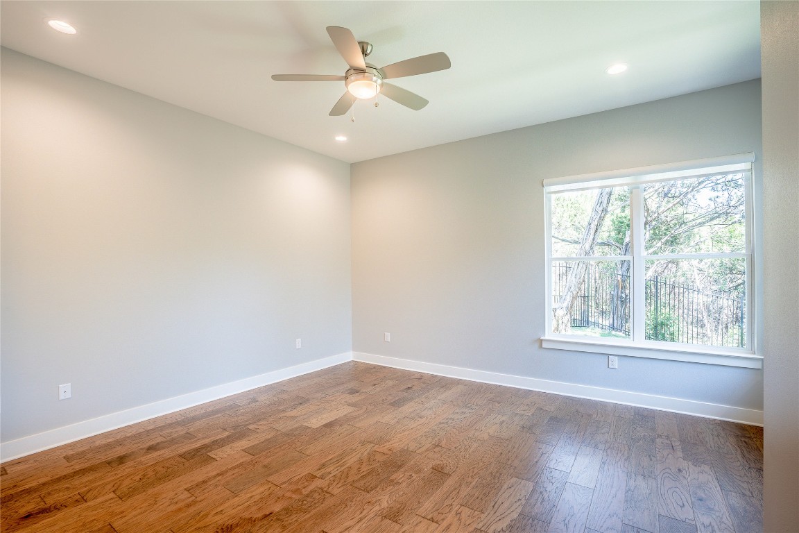 3018 Sunridge Drive, Unit 4 Austin, TX 78741 - Photo 19 of 34 an empty room with wooden floor and windows