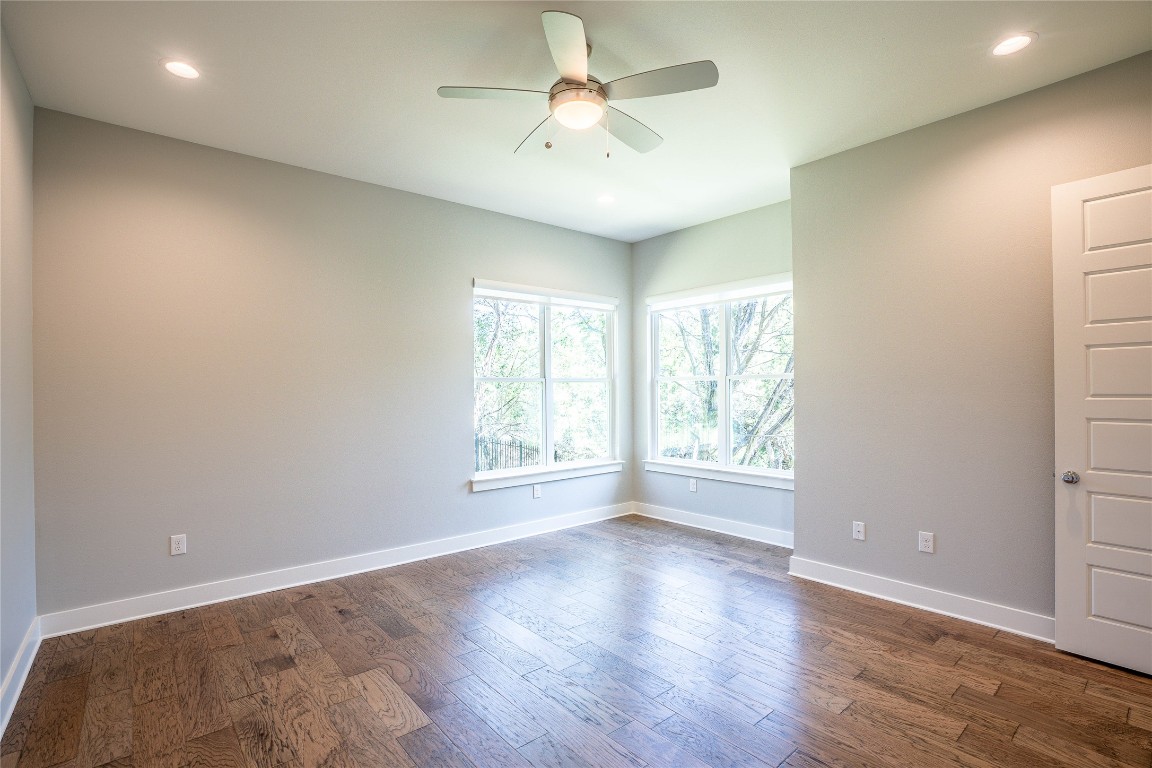 3018 Sunridge Drive, Unit 4 Austin, TX 78741 - Photo 21 of 34 an empty room with wooden floor and windows
