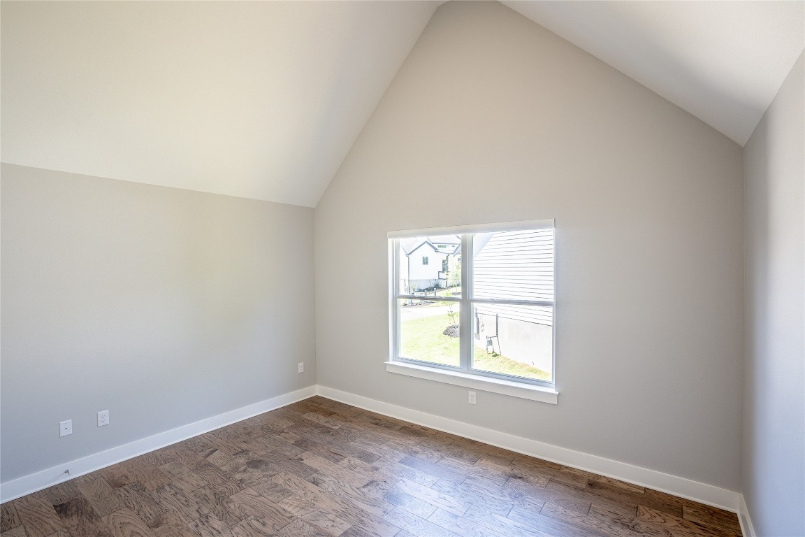 3018 Sunridge Drive, Unit 4 Austin, TX 78741 - Photo 22 of 34 an empty room with wooden floor and windows