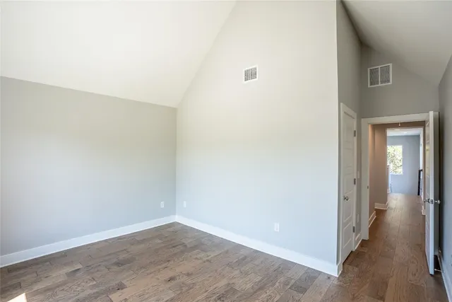 a view of a room with wooden floor