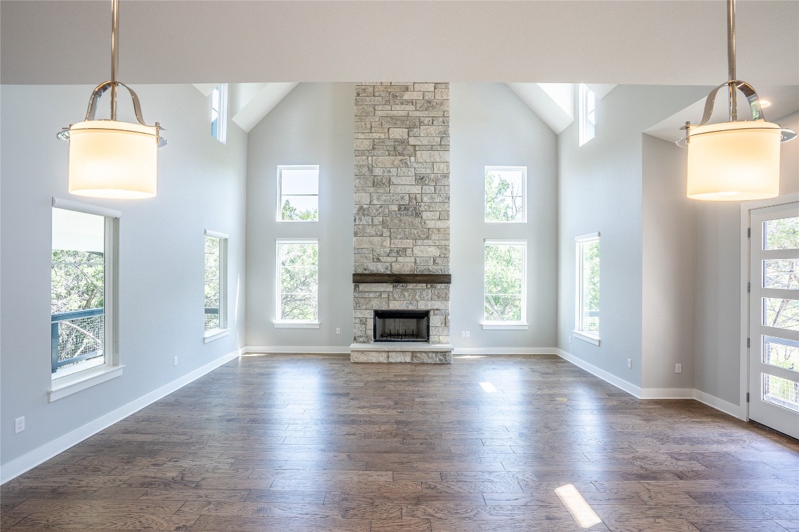 3018 Sunridge Drive, Unit 4 Austin, TX 78741 - Photo 4 of 34 an empty room with wooden floor fireplace and windows