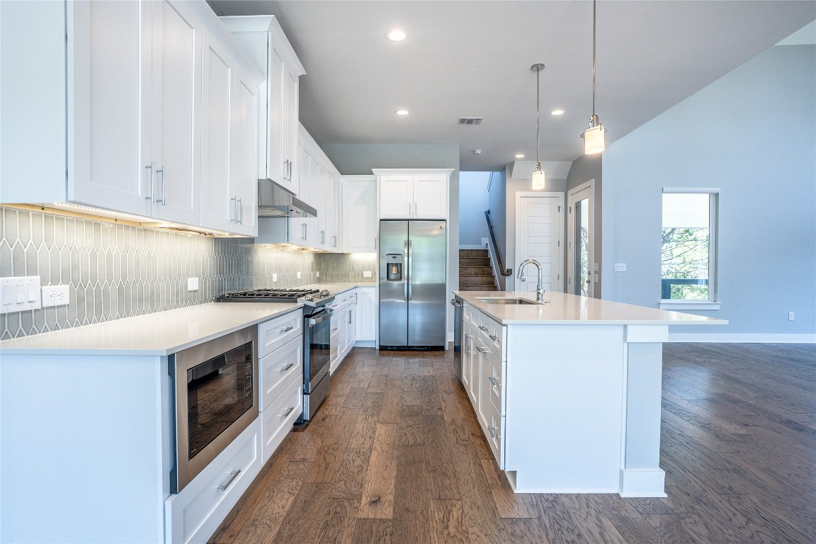 3018 Sunridge Drive, Unit 4 Austin, TX 78741 - Photo 8 of 34 a kitchen with stainless steel appliances granite countertop a stove a sink and a refrigerator
