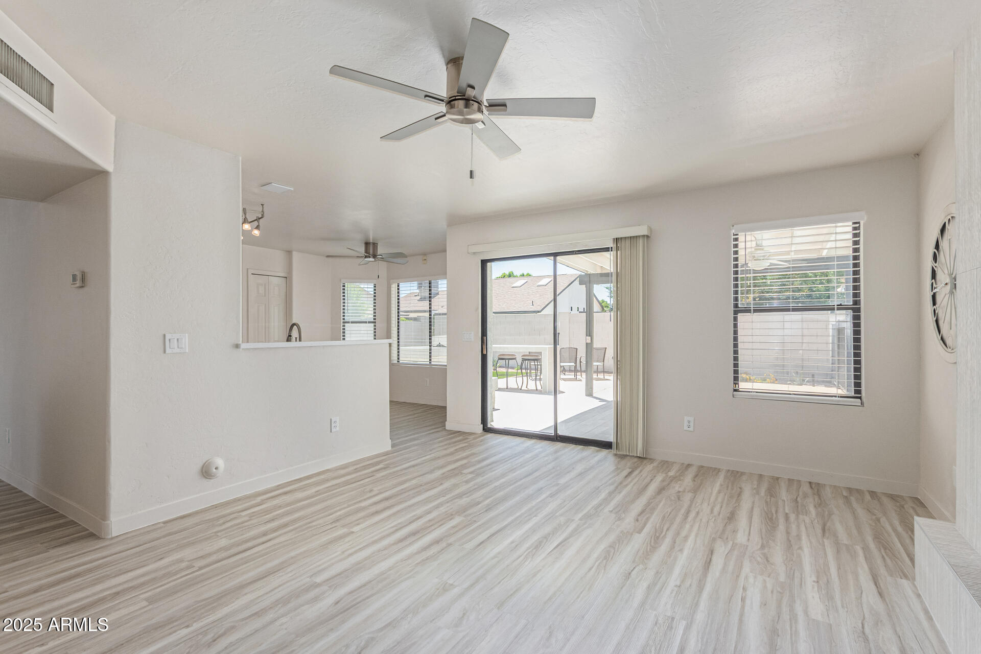 4933 East Downing Street Mesa, AZ 85205 - Photo 14 of 44 an empty room with wooden floor fan and windows