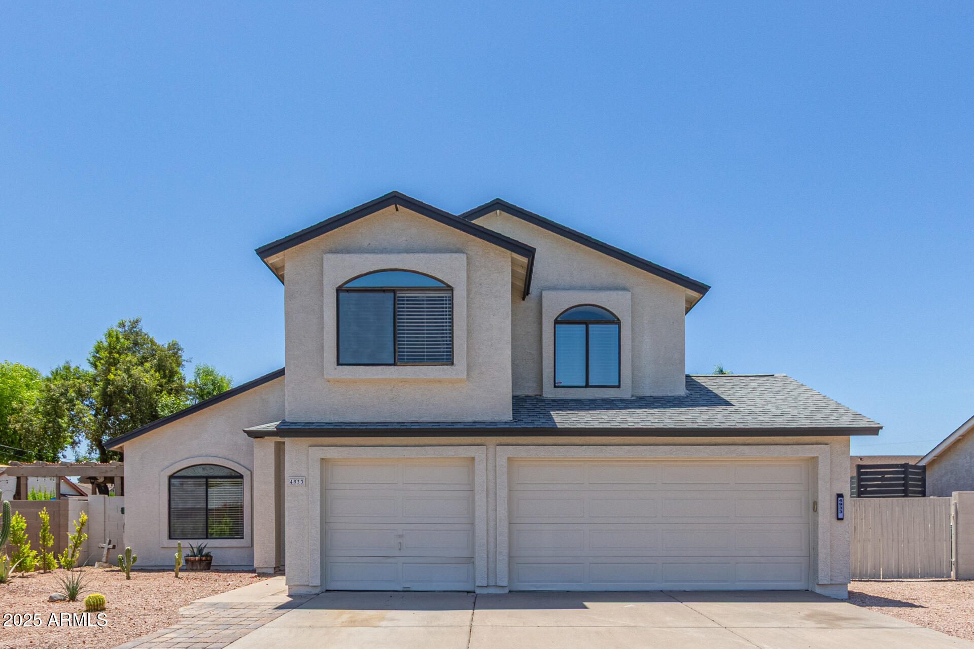 4933 East Downing Street Mesa, AZ 85205 - Photo 2 of 44 a front view of a house with a garage