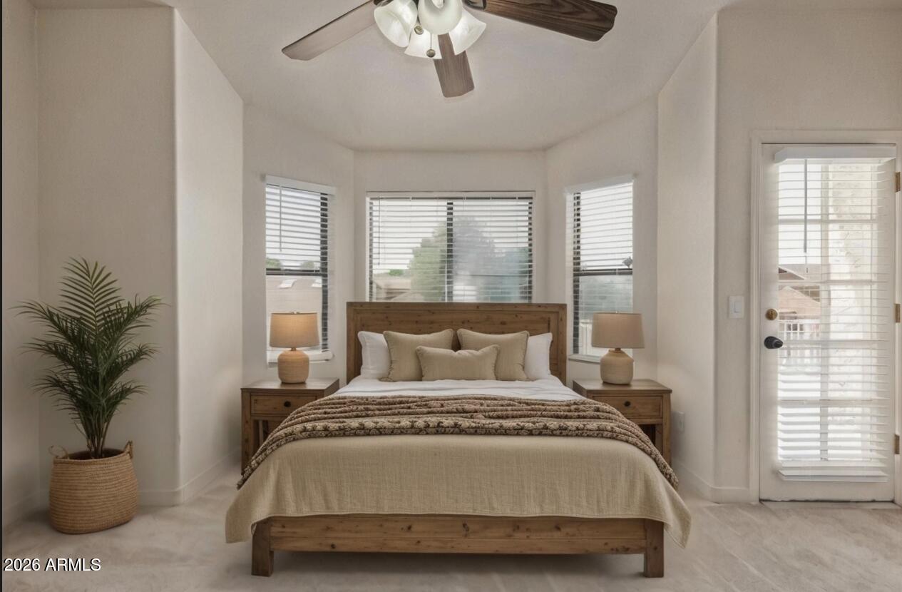 4933 East Downing Street Mesa, AZ 85205 - Photo 21 of 44 a bedroom with a large bed and a chandelier