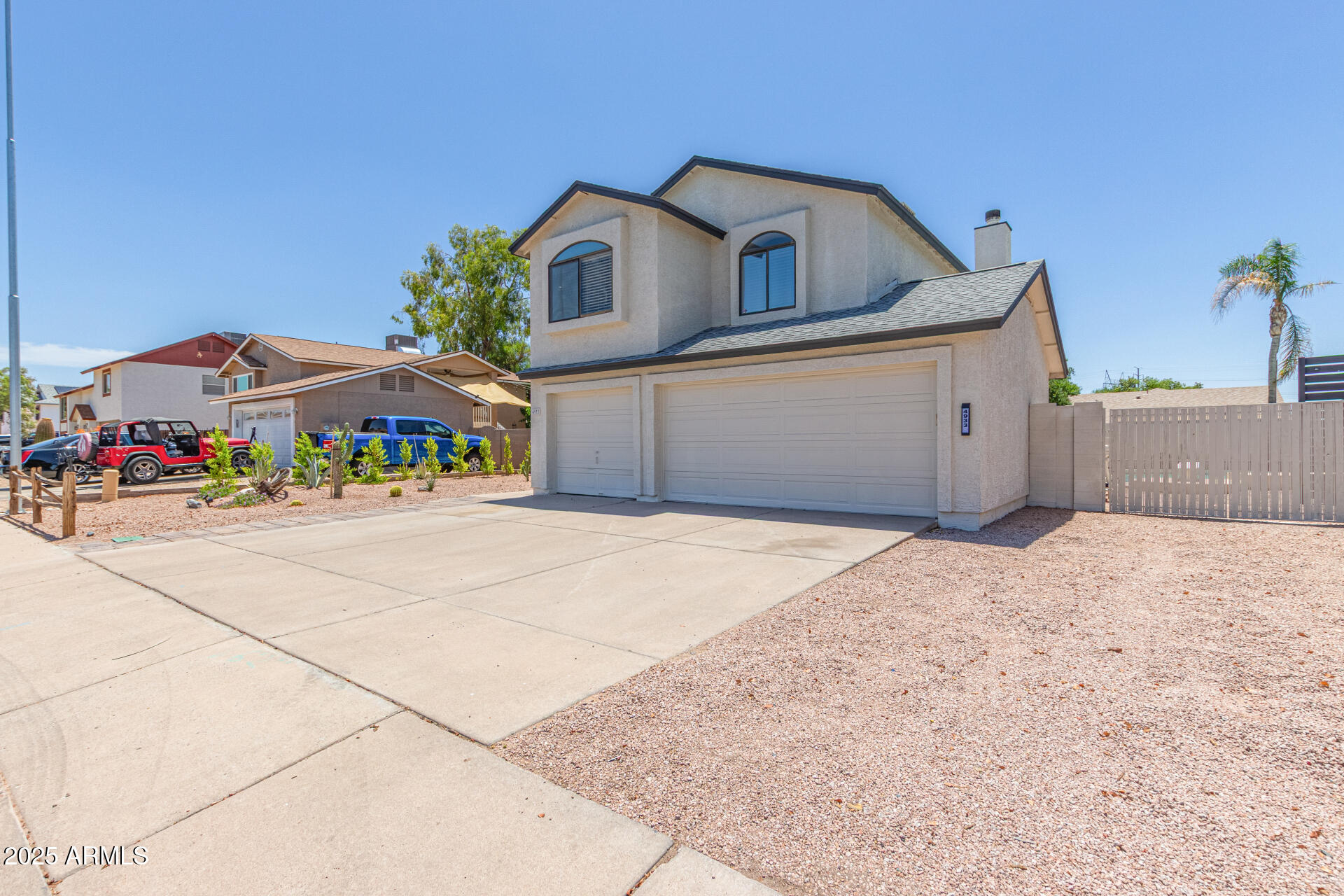 4933 East Downing Street Mesa, AZ 85205 - Photo 3 of 44 a front view of a house with a yard and garage