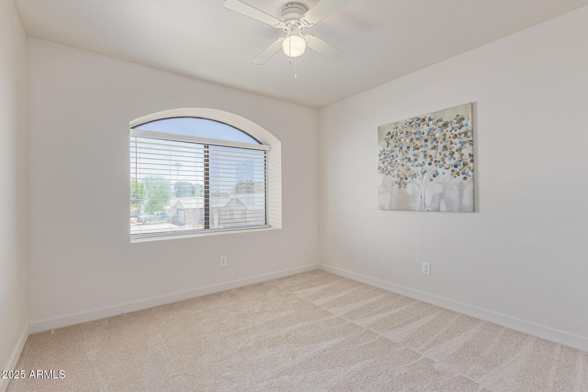 4933 East Downing Street Mesa, AZ 85205 - Photo 34 of 44 an empty room with a window and a fan