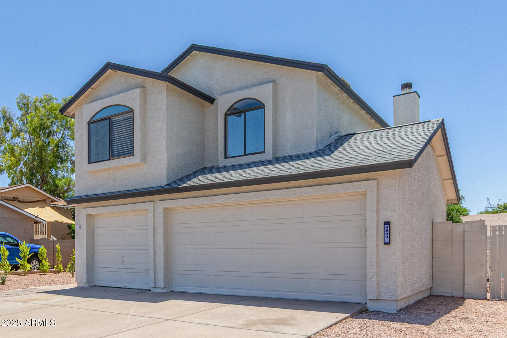 4933 East Downing Street Mesa, AZ 85205 - Photo 4 of 44 a front view of a house with a garage
