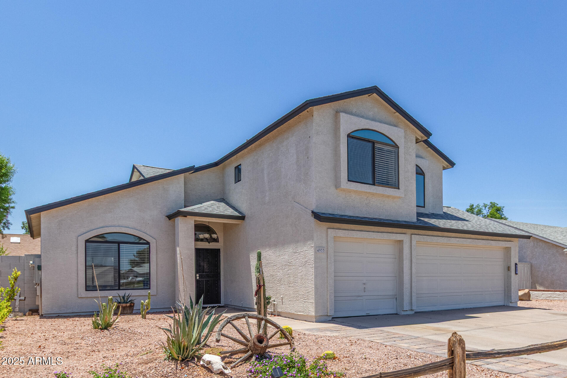 4933 East Downing Street Mesa, AZ 85205 - Photo 5 of 44 a front view of a house with a yard