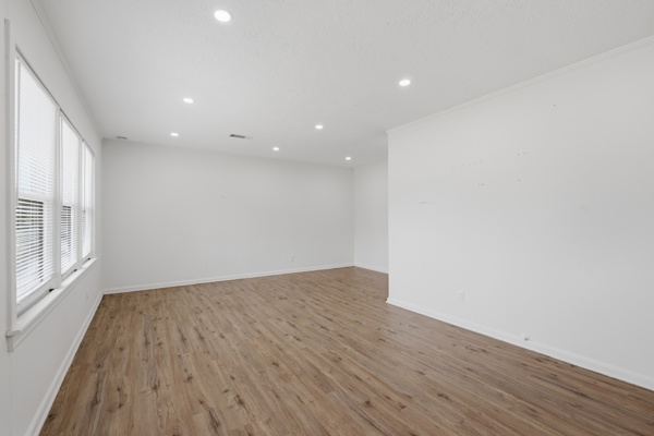 1608 Burt Street Bryan, TX 77802 - Photo 4 of 16 a view of an empty room with wooden floor and a window